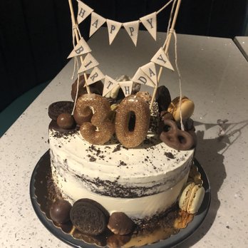 Suzi Cakes - a cake decorated with donuts and bunting flags - Bakeries Near Me - East Hanover, New Jersey