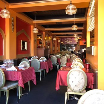 Coriander Green - a restaurant with tables and chairs - Indian Near Me - Oakville, Ontario