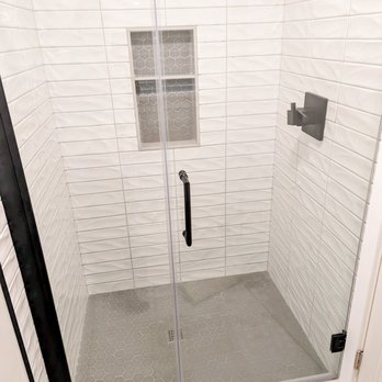 Blue Cord Contracting - a shower with a glass door - Kitchen & Bath Near Me
