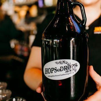 Hops n Drops - Smokey Point - a woman holding a growler - Burgers Near Me - Marysville, Washington Hops n Drops - Smokey Point - a woman holding a growler - Burgers Near Me - Marysville, Washington