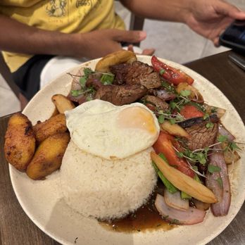Jarana - Lomo saltado Beef tenderloin with rice, add fried eggs and plantains (+5) - Peruvian Near Me - East Rutherford, New Jersey Jarana - Lomo saltado Beef tenderloin with rice, add fried eggs and plantains (+5) - Peruvian Near Me - East Rutherford, New Jersey