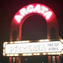 a neon sign for a pizzeria