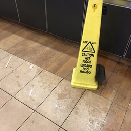 Don't clean it up. Put up a wet (and sticky) floor sign...