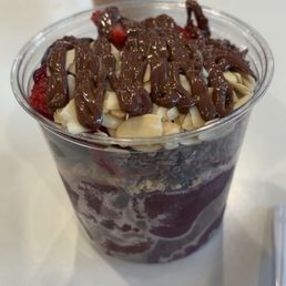 Açaí Bowl with strawberry, banana, almond, Nutella, chocolate nibs.