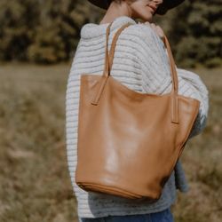 Local Assortment - Woman with leather handbag designed by Rebecca Beetham
