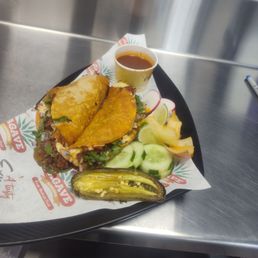 2 Quesabirria tacos with Chile y cebolla asada con pepino y rábanos y su limón 2 Quesabirria tacos with Chile y cebolla asada con pepino y rábanos y su limón