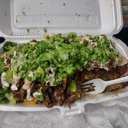 Two hefty sized potatoes with pork shoulder (pernil), bacon, broccoli, cheese and sour cream.