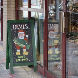 Orvis - A sidewalk sign with Orvis wishing all who pass by it, Happy Holidays