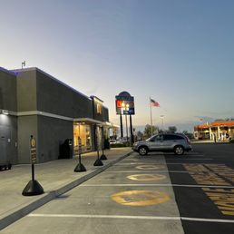 a parking lot with cars parked on the side of the road
