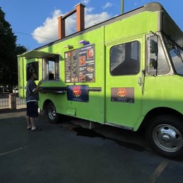 a woman ordering food from a food truck