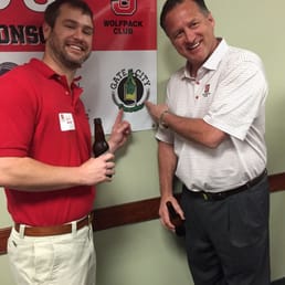 two men standing in front of a banner two men standing in front of a banner