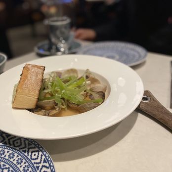 Grain and Cane - STEAMED MANILLA CLAMS: spring garlic, garlic bread, xo sauce - American Near Me - Berkely Heights, New Jersey Grain and Cane - STEAMED MANILLA CLAMS: spring garlic, garlic bread, xo sauce - American Near Me - Berkely Heights, New Jersey