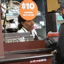 a man behind a counter at a restaurant a man behind a counter at a restaurant