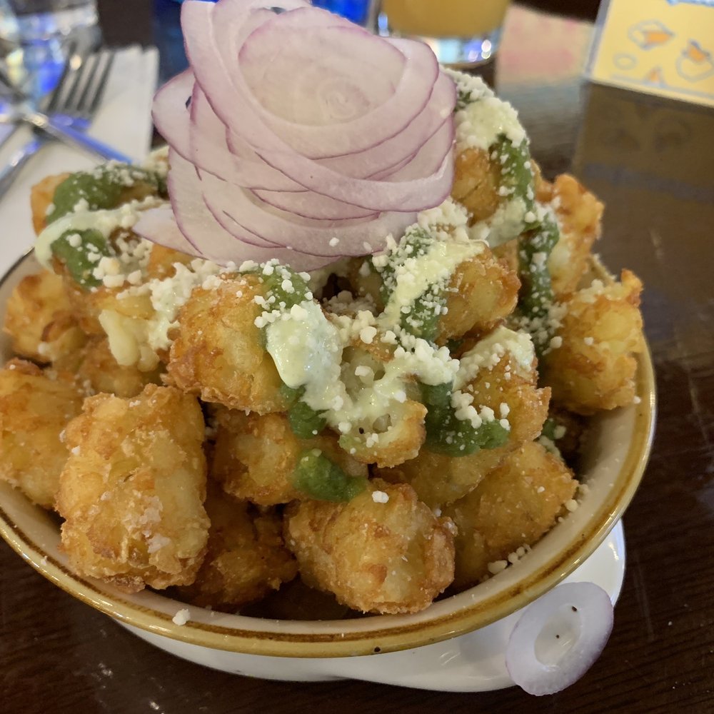 Sloop Brewing @ the Factory - "Chilaquiles" Tater Tots - salsa verde, red onions, cotija cheese, lime cilantro crema. Okay - tots needed to be crispier. - Breweries Near Me - Hopewell Junction, New York Sloop Brewing @ the Factory - "Chilaquiles" Tater Tots - salsa verde, red onions, cotija cheese, lime cilantro crema. Okay - tots needed to be crispier. - Breweries Near Me - Hopewell Junction, New York