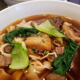 Spicy Beef and Tendon Soup with wide hand-pulled noodles. Perfect for a cold weather.