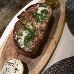 Sourdough bread appetizer with butter, black sesame seed and other container had a vinaigrette Sourdough bread appetizer with butter, black sesame seed and other container had a vinaigrette