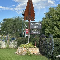Carter Inn - Private lawn area with business sign. There's pumpkins growing at base of sign!