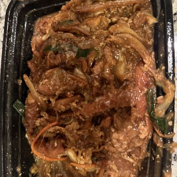 Grace Garden - Mushu pork without any cabbage. I was told on the phone that it is cooked into it. Apparently that's a new thing. - A black plastic takeout container contains Mushu pork without cabbage, with shredded pork, vegetables such as carrots and green onions, all coated in a savory sauce. The dish appears moist and is served in a typical takeout presentation, likely from a Chinese-American restaurant offering a variety of dishes including Mongolian beef and orange chicken. - Chinese Near Me - Gilbert, Arizona