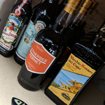 Drink PLG - a variety of alcohol bottles and a bottle opener - Beer, Wine & Spirits Near Me - Brooklyn, New York