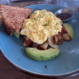 Farmhouse Skillet.  Eggs, avocado, toast, on top of seasoned potatoes.   Served with a jam