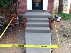 Masonry/Concrete Repair - We specialize in all types of concrete and masonry. When we do masonry repairs to an existing structure, we go out of our way to match mortar color and brick style.

Our standards demand that the concrete is to the proper thickness—many contractors only use wooden 2×4 forms, which actually are 3 1/2 inches tall. The result of doing so leaves you with a thinner slab. We use metal forms when possible, and our slabs have a minimum of 5″ thickness. We use heavy wire-reinforcing metal in 5’x10′ sheets supported by high chairs; this ensures that reinforcement is up in the concrete, not laying on the ground like most other companies.

We take our time to make sure that slabs are sloped correctly and in a direction away from structures. Just as importantly, you are not left with a mess! We thoroughly clean up when the job is done!

We also only use local concrete plants. This helps us to avoid ‘hot loads’ — loads that require excessive amounts of water and result in a substandard mix of concrete.

Here are just a few types of masonry and concrete projects that we can offer you:
- Addition footings
- Driveways and patio
- Concrete walls to existing structures
- Chimney repairs
- House wall cracks in bricks
- Retaining walls
- Garage floor replacements
- Settle basement floor replacements
- Egress window and window wells
- Hairlines cracks
- We cut holes in foundation walls for windows and doors
