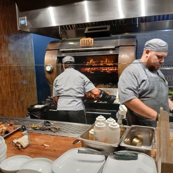 Dando La Brasa - Cooking chickens - Salad Near Me - Miami, Florida