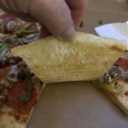 Pizza Hut - Under cook crust on a hand tossed pie.