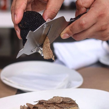 Sabatino Truffles - a person cutting a piece of steak - Specialty Food Near Me - New York, New York Sabatino Truffles - a person cutting a piece of steak - Specialty Food Near Me - New York, New York
