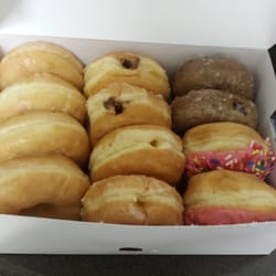 Donut Hole - Pictured here is their original glazed, chocolate filled, Bavarian cream filled and glazed blueberry cake donuts.
