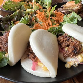 Blackback Pub - Barbacoa Brisket buns with Eloté, chipotle-maple vinaigrette, pickled onion, cilantro, side greens with chipotle-maple vinaigrette - Pubs Near Me - Waterbury, Vermont