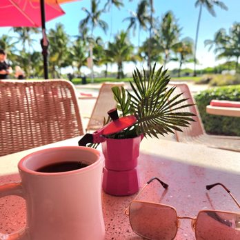 Call Me Cuban - a cup of coffee and sunglasses on a table - Cuban Near Me - Miami Beach, Florida