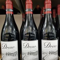 a row of wine bottles on a shelf