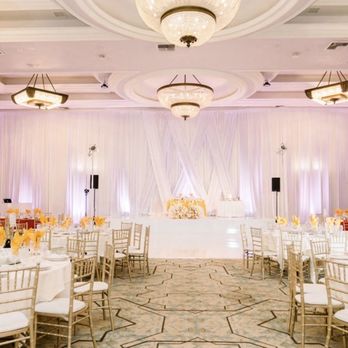 TMMPRO - Draping w/ middle section enhancement, seamless white dance floor and wrapped stage, romantic up lights, and gold Chivari chairs. - DJs Near Me - South El Monte, California