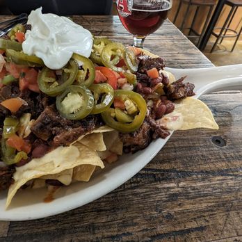 Avery Brewing - BRISKET NACHOS -  smoked brisket, red beans, nacho cheese, pickled jalapeño, crema, pico - Breweries Near Me - Boulder, Colorado