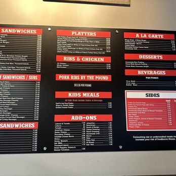 Chaps Pit Beef - The image shows a black menu board with red headers and white text, listing food options at a Baltimore BBQ restaurant. Sections include pit sandwiches, specialty sandwiches, platters, ribs, chicken, kids meals, add-ons, desserts, beverages, and sides. Prices are displayed next to each item, and the menu emphasizes Baltimore-style BBQ offerings such as pit beef, turkey, ham, ribs, and sides like baked beans and coleslaw. - Barbeque Near Me - Baltimore, Maryland