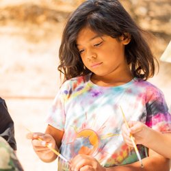 SYV Family School - Students watercoloring outdoors.