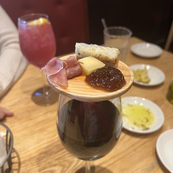 Carrabba's Italian Grill - My house wine with small charcuterie on top of the wine glass! - Italian Near Me - Knoxville, Tennessee