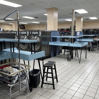 Ultra Modern Laundry - Many clean, double-decker folding tables at both ends of all the aisles. - Laundry Services Near Me - Kansas City, Kansas