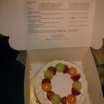 Fay Da Bakery - Flavor-less sponge cake with heavy cream, melons, cantaloupes,strawberries on top & almonds on the side - Bakeries Near Me - New York, New York