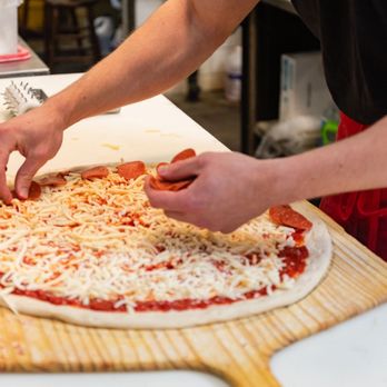 Doggie's Pub - a man making a pizza - Bars Near Me - State College, Pennsylvania Doggie's Pub - a man making a pizza - Bars Near Me - State College, Pennsylvania