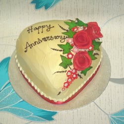 The Scrumptious Cakes - Special Occasion Cakes available in eggless as well- Heart shaped cake with Flowers.