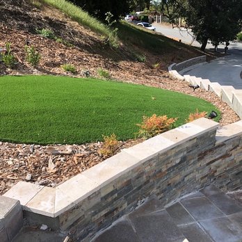 Marquez Landscape - Driveway and lower retaining wall with artificial grass - Landscaping Near Me