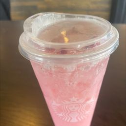 a pink drink in a plastic cup a pink drink in a plastic cup