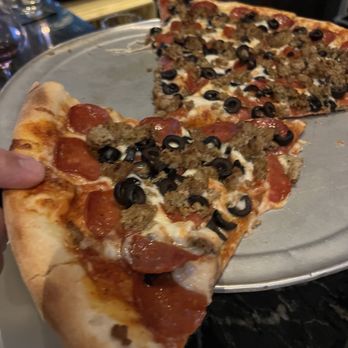Rocco's - Delicious pizza with sausage, pepperoni, and black olives! - Bars Near Me - Seattle, Washington