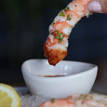 Tavern - a person dipping shrimp into a bowl of sauce - New American Near Me - Fort Worth, Texas Tavern - a person dipping shrimp into a bowl of sauce - New American Near Me - Fort Worth, Texas