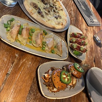 Moku Kitchen - 1) Hamakua Mushroom and Truffle oil Pizza  2) Bulgogi Sliders 3) Pork Potstickers  4) Poke Tacos - Cocktail Bars Near Me - Honolulu, Hawaii