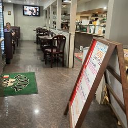 Interior - pizza display case and seating area.