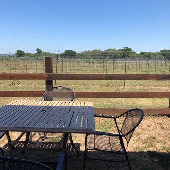 Solaro Estate - a table and chairs in a fenced area - Wineries Near Me - Dripping Springs, Texas Solaro Estate - a table and chairs in a fenced area - Wineries Near Me - Dripping Springs, Texas