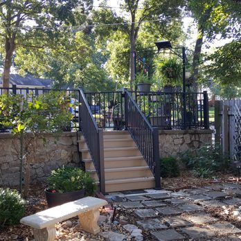 RCW Construction - Terraced patio and backyard seating area w/ Fortress AL13 railing, stairs and KS Cut Limestone on the wall - General Contractors Near Me - Tonganoxie, Kansas