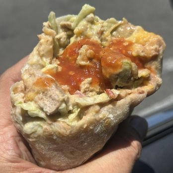 Miguel's Jr - The garbage burrito with chili verde pork and the fresh hot sauce - Mexican Near Me - Orange, California